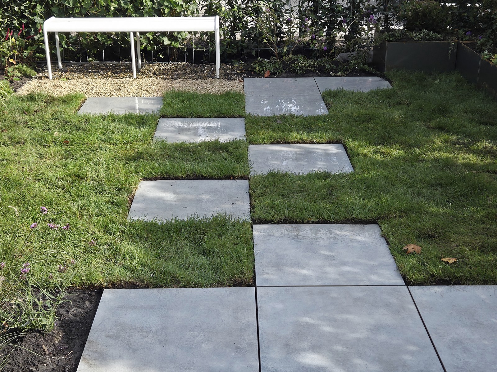 Concrete stepping stones between the grass and the paving in the show garden